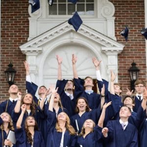 Students throwing hats at graduation